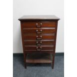 An antique mahogany five drawer music chest containing sheet music