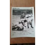 RUGBY LEAGUE, press photo, possibly Huddersfield v Wigan, showing action on snow-covered pitch,