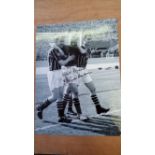 FOOTBALL, signed 12 x 15 photo of Bert Trautmann, full-length walking off the pitch holding his neck