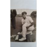CRICKET, press photo, Peter Burge, kneeling on floor fitting pads, 8 x 10, knocks to edges, slight