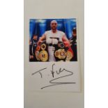 BOXING, signed piece by Tyson Fury, laid down to card beneath photo showing him with belts, 6 x 8.