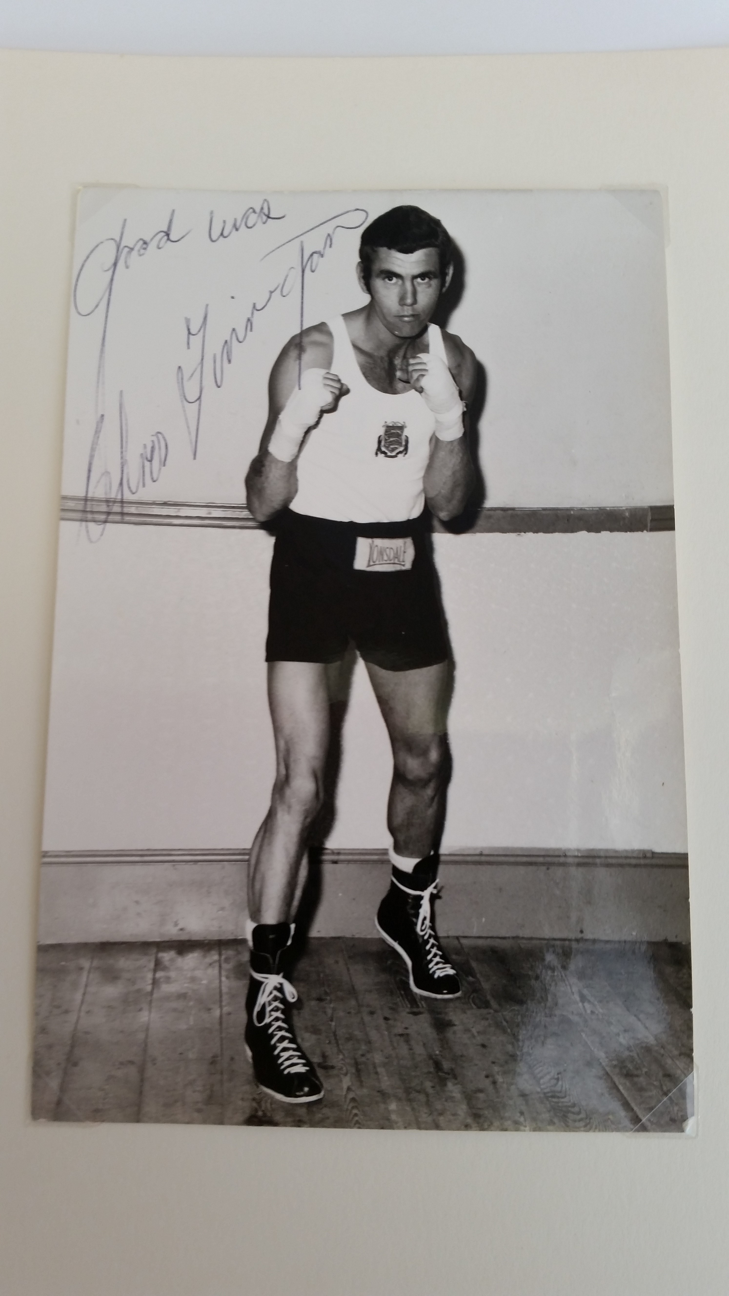 BOXING, signed photo by Chris Finneghan, corner-mounted to card showing him full-length in boxing