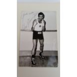 BOXING, signed photo by Chris Finneghan, corner-mounted to card showing him full-length in boxing