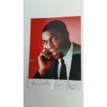 BOXING, signed photo by Frank Bruno, corner-mounted to card showing him h/s in civilian clothes, 6 x