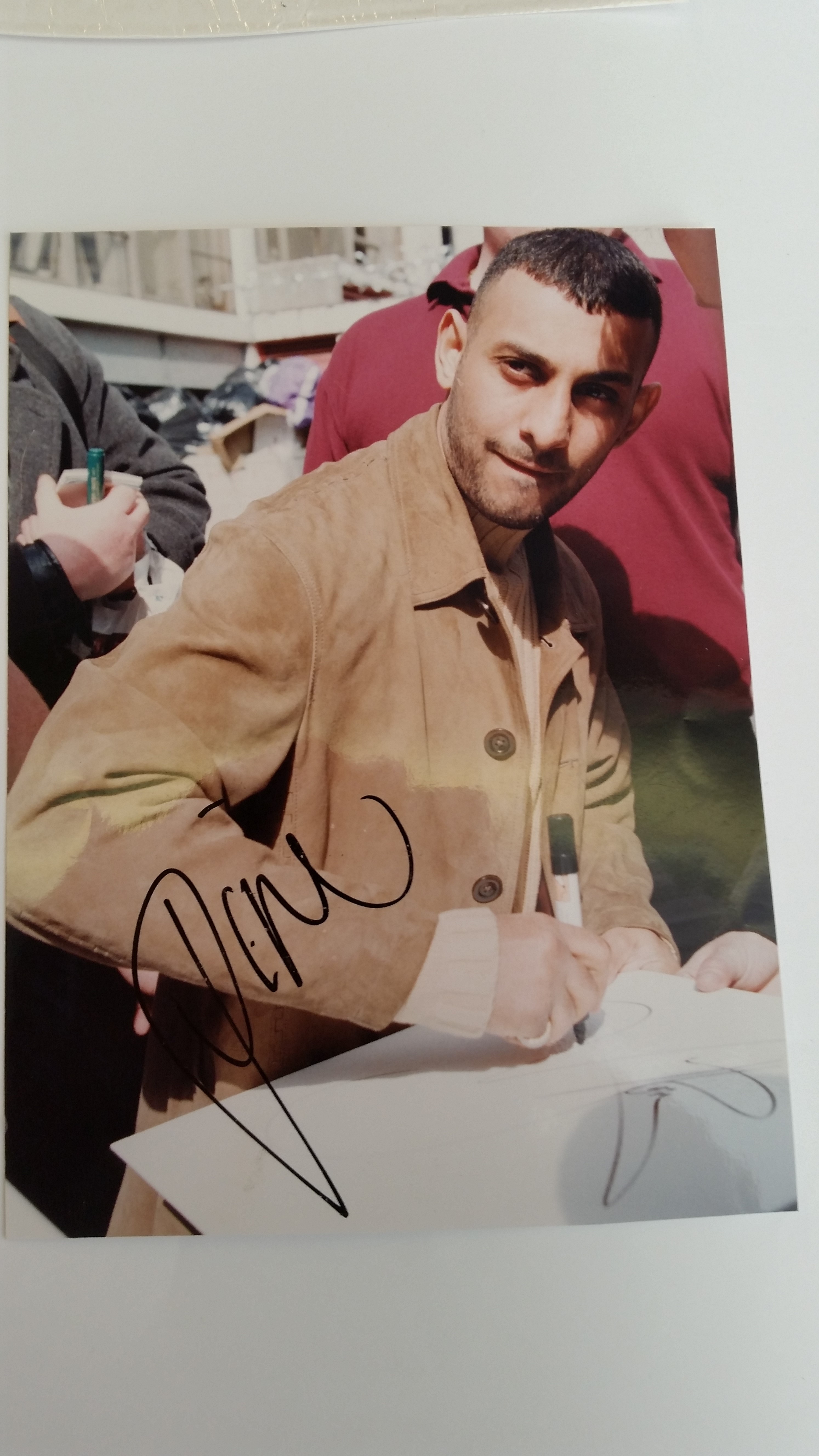 BOXING, signed photo by Prince Naseem, showing him half-length in civilian clothes signing, 5.5 x