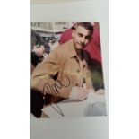 BOXING, signed photo by Prince Naseem, showing him half-length in civilian clothes signing, 5.5 x