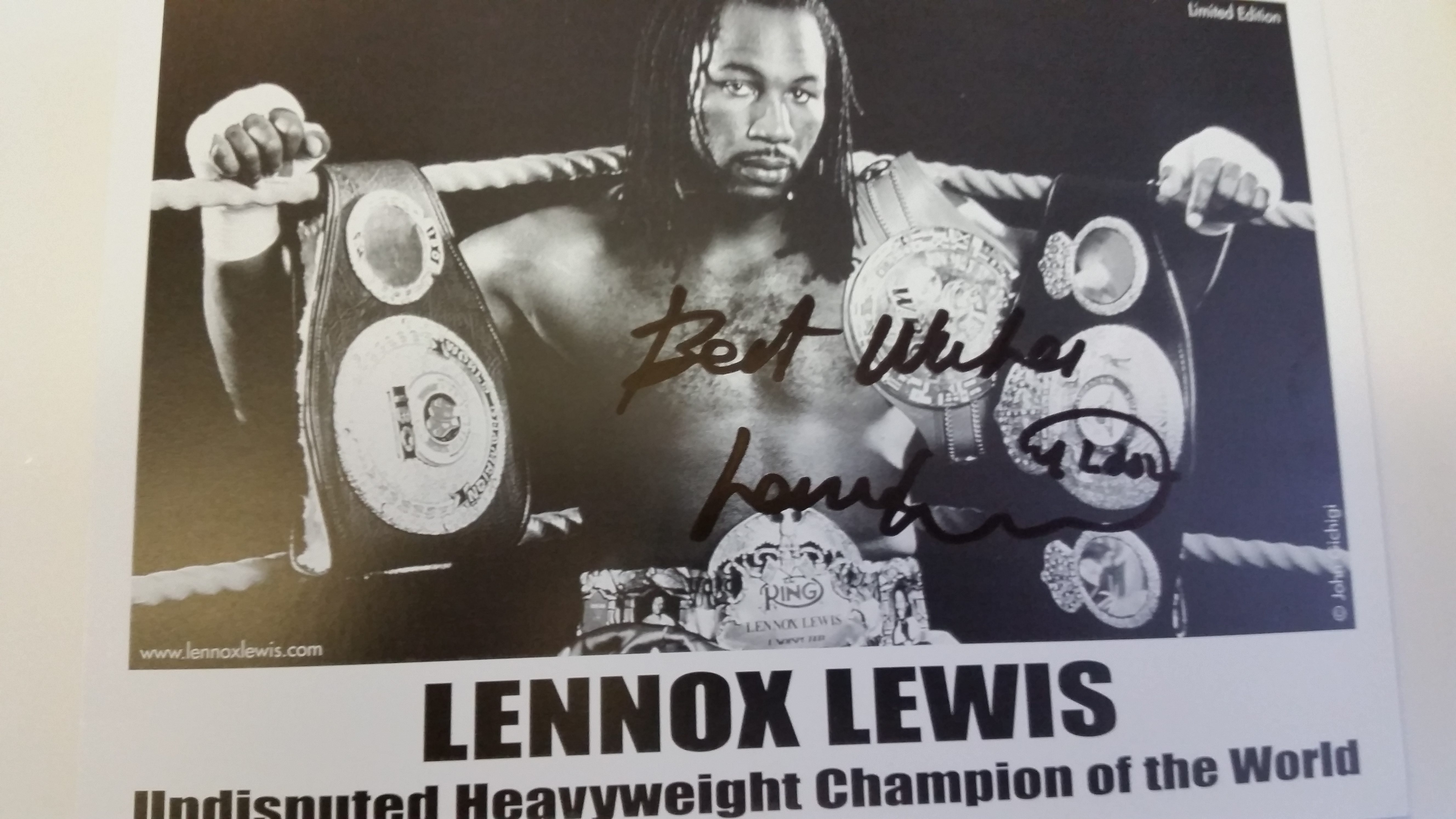 BOXING, signed promotional card by Lennox Lewis, half-length in ring with belts, 6 x 8.5 overall,