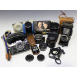 An Olympus OM10 camera with Zuiko 50mm 1:1.8 lens, a Super Paragon auto tele-zoom lens, a Vivitar MC
