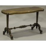 A late Victorian walnut centre table, the shaped top raised on turned and fluted supports and carved
