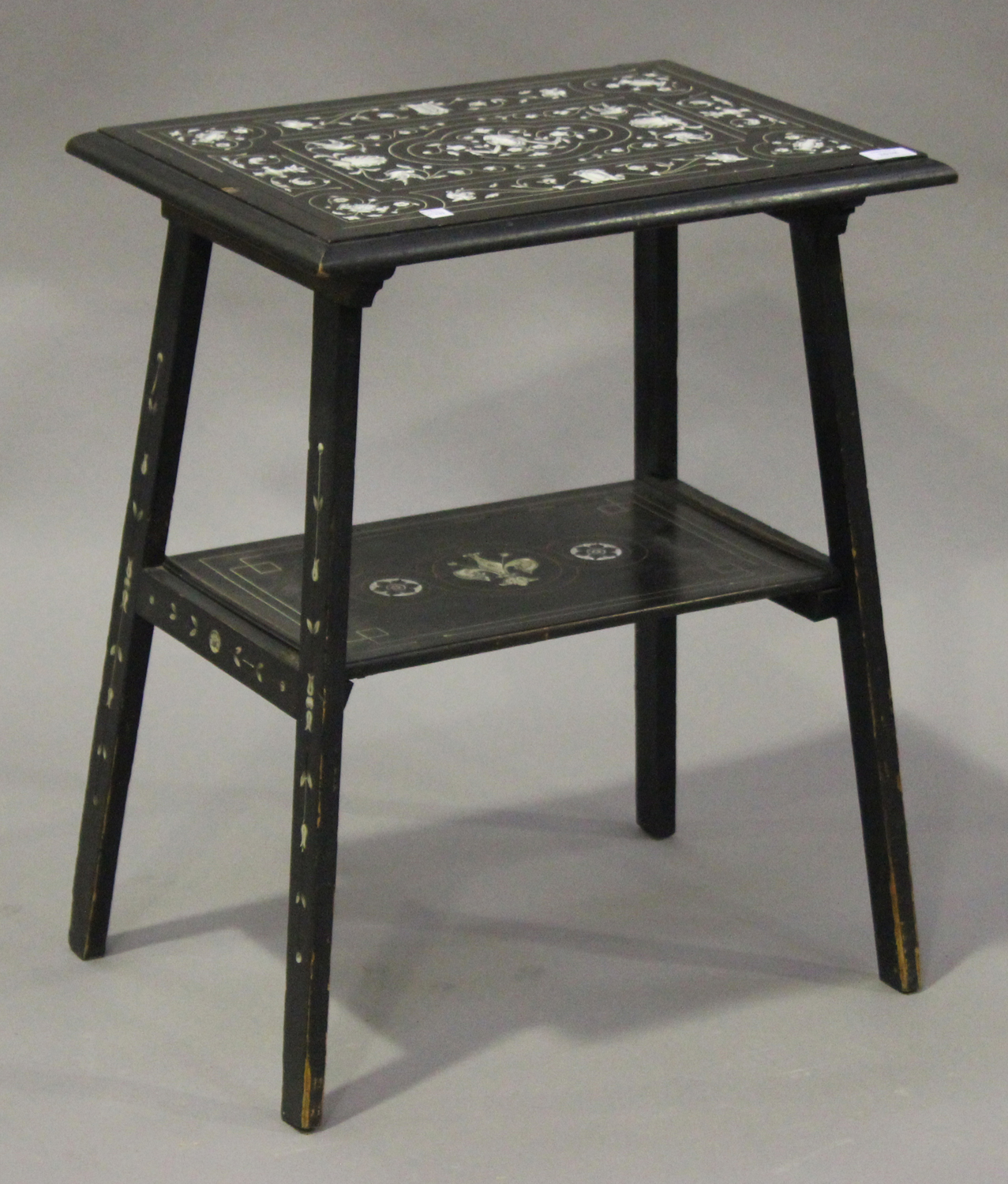 A late 19th century Italian ebonized two-tier occasional table with ivory inlaid decoration, on