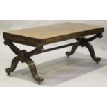 A French Empire mahogany library table, the rectangular top raised on 'X' scroll frame supports,