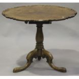 A George III and later mahogany piecrust wine table, on a turned baluster column and carved tripod