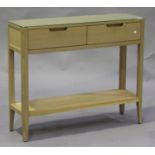 A modern oak side table by Marks & Spencer, fitted with two drawers, raised on block legs united
