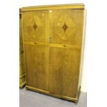 A George V Art Deco oak and walnut inlaid gentleman's wardrobe, fitted with an interior mirror,