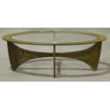 A G-Plan teak oval coffee table, the top inset with glass, raised on shaped supports, height 41cm,