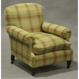 A George V armchair, upholstered in a check fabric, on turned legs and castors, height 93cm, width