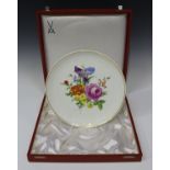 A Meissen porcelain cabinet plate, 20th century, painted with flowers within a gilt line border,