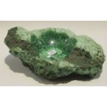 A large partially polished section of malachite, the centre formed as a dish, length 42cm.Buyer’s