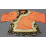 A Chinese coral coloured silk embroidered short jacket, late Qing dynasty, the borders and collar