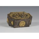 A Tibetan gilt-embellished white metal box, probably 19th century, the hinged lid applied with a