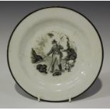 A New Hall porcelain plate, circa 1800, printed in black with a gentleman fisherman within a black