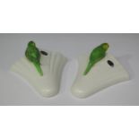 Two Sylvac pottery wall pockets, each mounted with a green budgerigar, height 22cm.Buyer’s Premium