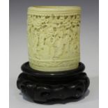 A Chinese Canton export ivory brushpot, mid-19th century, the exterior carved in relief with a