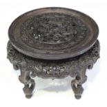 A Chinese hardwood stand, late 19th/early 20th century, the circular top finely carved and pierced