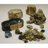 A mixed group of mineral and wood specimens, including two sections of fossilized wood, a section of