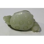 A Chinese jade pendant, late Qing dynasty, carved and pierced in the form of a lotus pod, leaves and