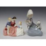 A Royal Doulton figure 'The Bedtime Story', HN2059, together with a Lladro figure of Dog and Cat,