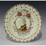 A Leeds creamware Dutch decorated plate, late 18th century, enamelled with a head and shoulder