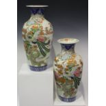 A pair of Japanese Imari porcelain vases, Meiji period, each shouldered tapering body painted with