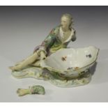 A Meissen porcelain figural sweetmeat dish, late 19th century, modelled as a reclining gallant