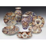 A pair of Japanese Imari porcelain circular plates, Meiji period, each painted and gilt with a