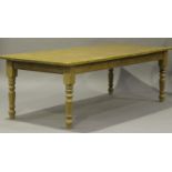 A modern pine rectangular kitchen table, raised on turned tapering legs, height 77cm, length