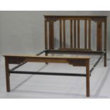 An Edwardian Arts and Crafts style walnut bed frame with carved decoration, height 111cm, width