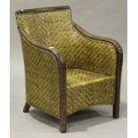 A mid-20th century mahogany framed wicker club armchair, height 88cm, width 67cm.Buyer’s Premium