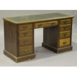 An Edwardian mahogany twin pedestal desk, the moulded top inset with a gilt-tooled green leather