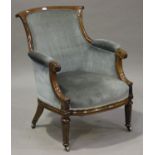 A William IV rosewood showframe armchair, upholstered in blue velour, raised on turned and tulip