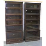 A pair of George V oak Globe Wernicke six section bookcases with glazed doors, on plinth bases,