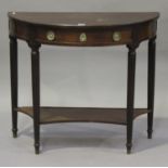 A French Empire mahogany demi-lune side table, the moulded top above a dummy drawer, raised on