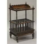 A Victorian rosewood Canterbury whatnot, the gallery top raised on bobbin turned supports, on