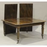 An early Victorian mahogany extending dining table with two extra leaves, the rectangular top raised