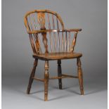 A mid-19th century yew, elm and ash Windsor armchair with a pierced splat back, the solid seat