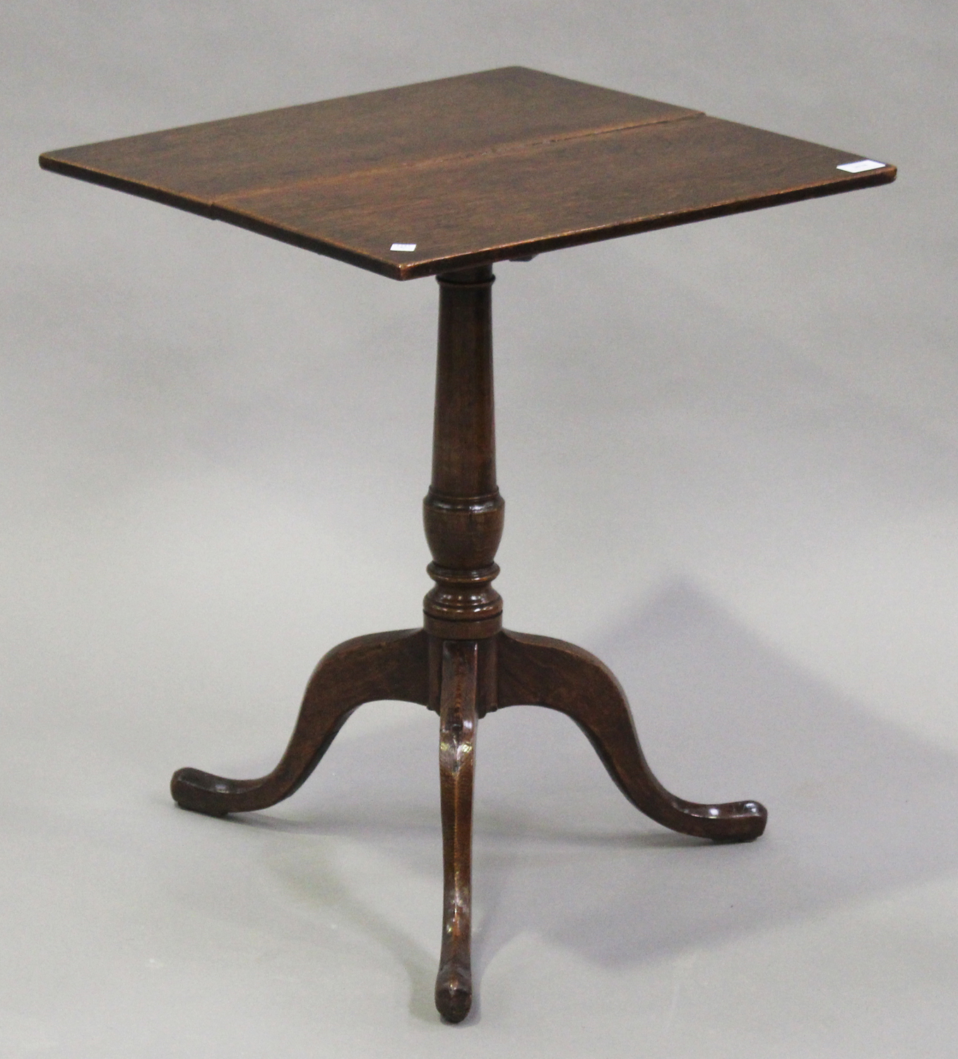 A George III oak tip-top wine table, the square top on a turned column and tripod legs, height 67cm,