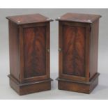 A pair of late 20th century reproduction mahogany bedside cabinets, each fitted with a panel door,