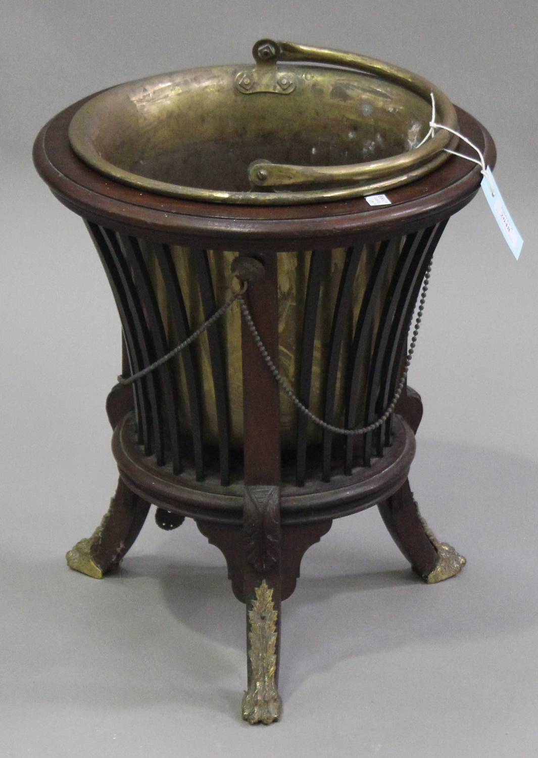 A late 19th century mahogany coal bucket of neoclassical form with gilt metal mounts, on outswept