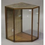 An early 20th century oak framed glazed shop corner display cabinet, height 69cm, width 70cm.Buyer’s