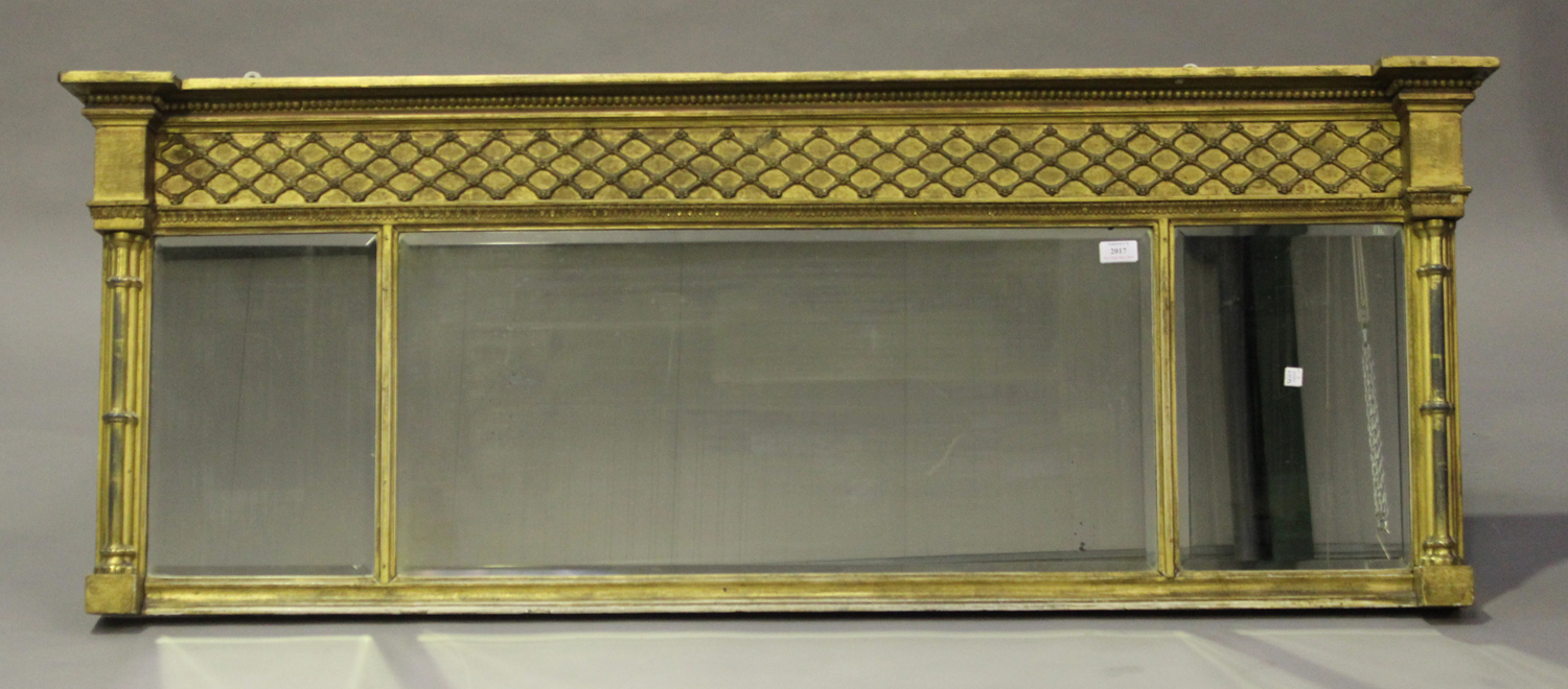 A Regency giltwood and gesso three-section overmantel mirror, the lattice moulded frieze above